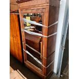 A continental figured walnut wardrobe with mirrored door.