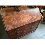 A George III inlaid mahogany bureau with fitted interior.