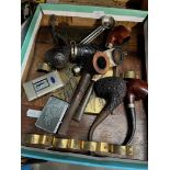 A selection of smokers pipes, 2 lighters, and a pipe rack with the inscription Smoke and be Happy