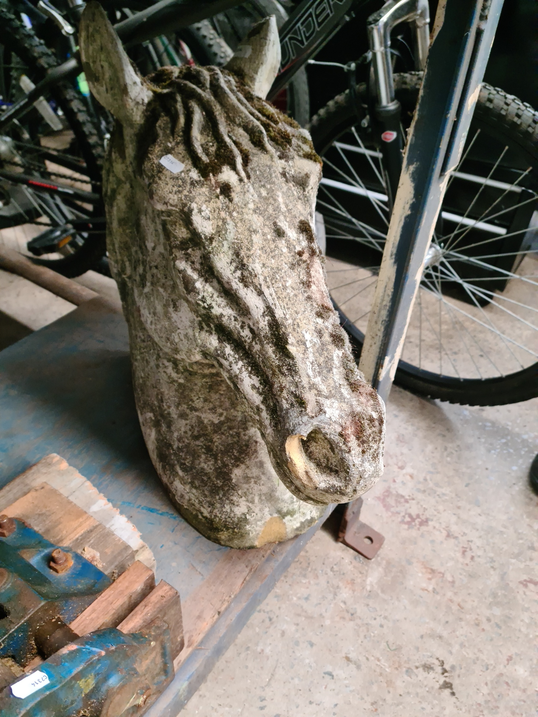 A horses head concrete garden ornament