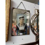 An early 20th century mirror with a coloured photograph of a sailor.