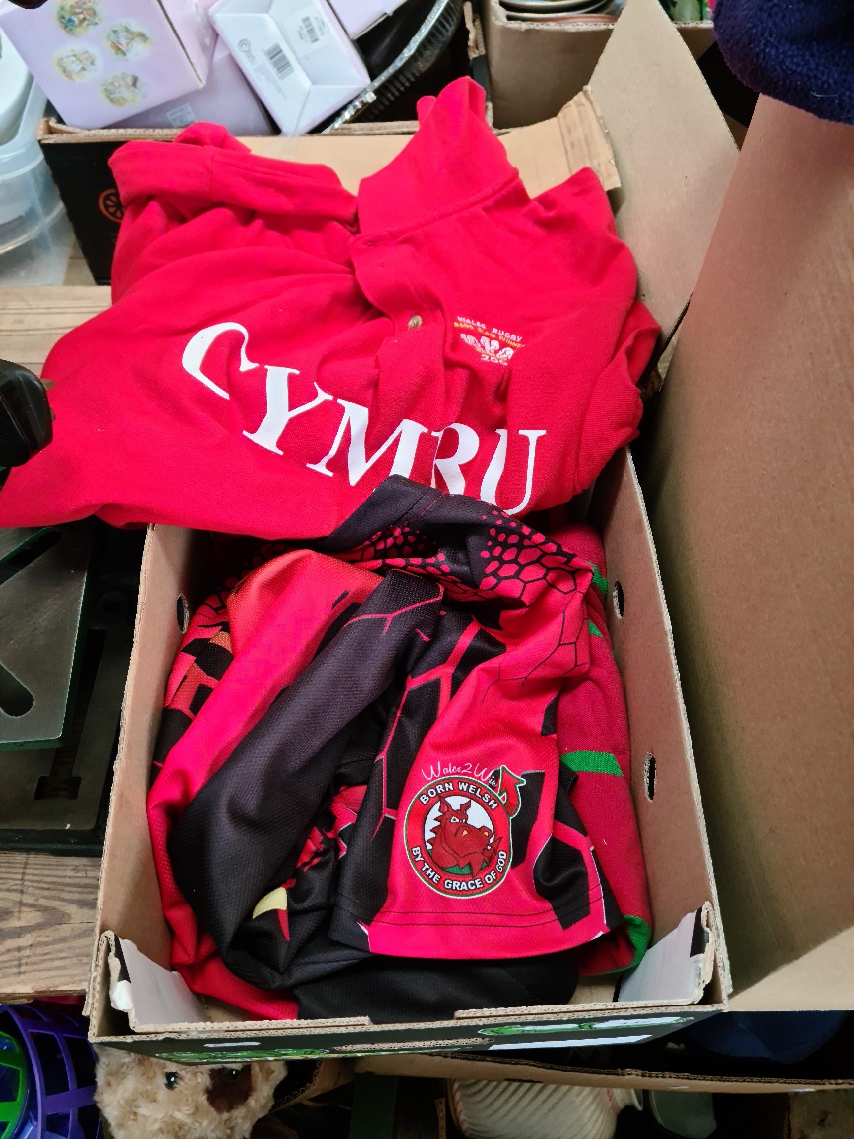 Three Welsh national team rugby union jerseys and a supporters shirt