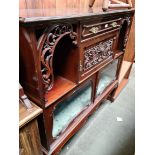 An Edwardian carved mahogany side cabinet with glazed doors.