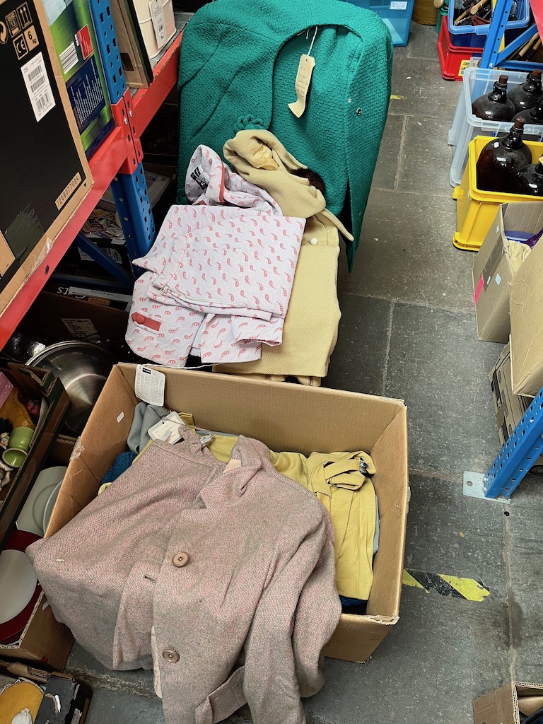 A box of vintage women's suits, mainly 1960s.