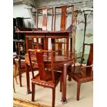 A Chinese carved hardwood extending dining table and 6 chairs.