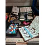A mixed box of metalware including silver plate, boxed cutlery sets, hip flask etc.