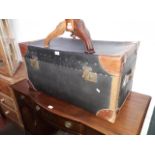 A large leather bound trunk and a vintage suitcase