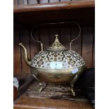 An Oriental cold painted brass tea pot with lid and handle.