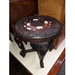 A carved wood elephant table, inlaid to top, circa 1900.