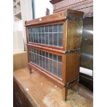 An oak and leaded glass sectional bookcase.