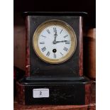 A late 19th century French slate mantel clock with pendulum and key.