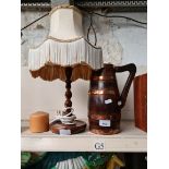 Twist oak table lamp and a copper mounted wooden jug
