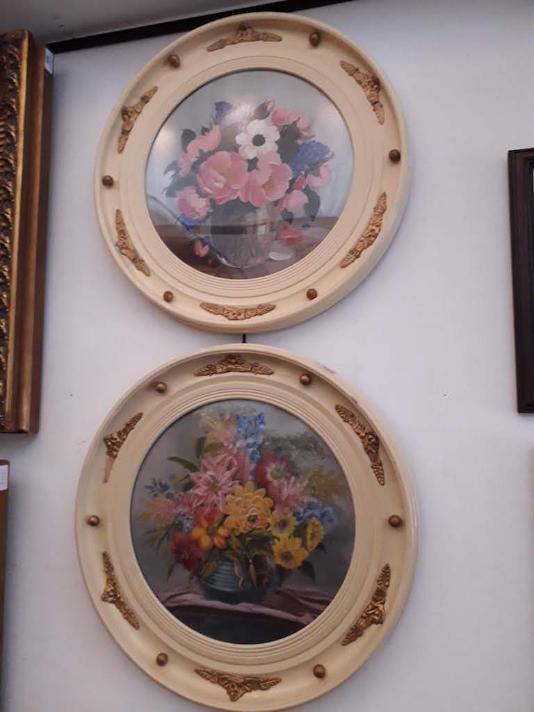 A pair of 20th century school, oil on boards, still life of flowers, 34cm diameter, one signed
