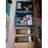 A box of vintage Telsen radio transformers, 23 plus condensers and four radio station glasses.