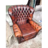 A brown leather Chesterfield reclining armchair.