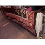 A large Chinese wool carpet; brown ground decorated with flowers.