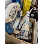 A box of sea shells and various seaside related ornaments.