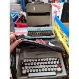 Two Olivetti typewriters in cases.