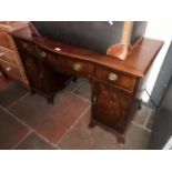 An Edwardian mahogany kneehole desk.
