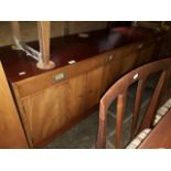 A mid 20th century mahogany sideboard and matching table and chairs.