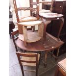 An oak drop leaf table table and four rush seated chairs, an oak circular coffee table and a