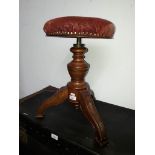 A Victorian walnut adjustable piano stool.