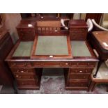 A Victorian mahogany kneehole desk with writing slope.
