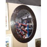 A 1920's oak framed oval mirror.