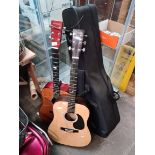 Two accoustic guitars, a guitar case and two miniature guitars.