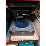 A gramophone and a box of old records.