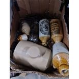 A box of collectables including stoneware bottles, drawer handles etc.