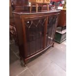 An early 20th century mahogany display cabinet on ball and claw feet.