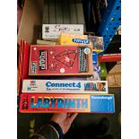 A box of board games including Connect 4, Triominoes etc