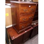 A mahogany chest of drawers and a walnut side cabinet.