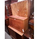 A mid 20th century teak bureau and a 1930s oak wardrobe.