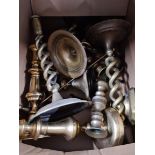 A box of brassware, mainly candlestick holders.