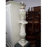 A white lamp on pedestal base.