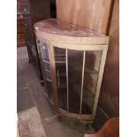 An early 20th century bow front mahogany display cabinet.