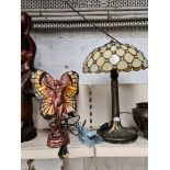 Two modern Tiffany style table lamps, one in the form of a woman with butterfly wings.