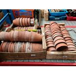 Three wooden crates containing terracotta plant pots.