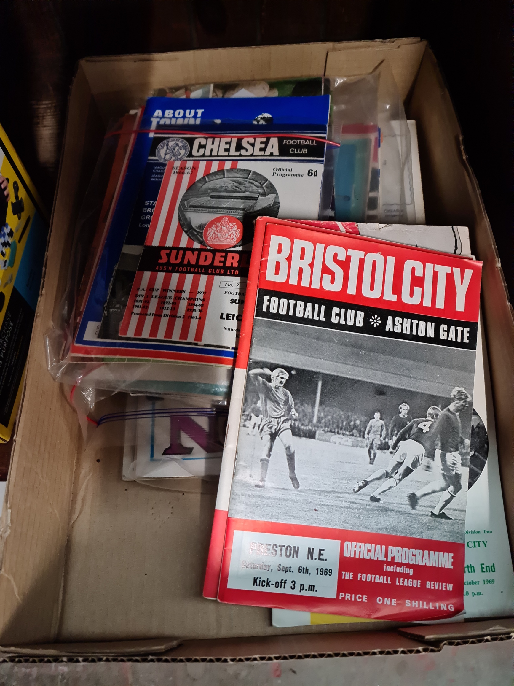 A box of football programmes.