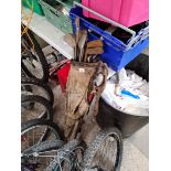 A vintage golf bag with hickory and other golf clubs.