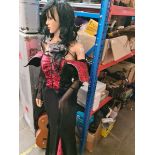A female mannequin with halloween dress & a box of halloween items