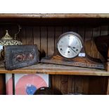 An embossed leather hand bag and a chiming mantle clock .