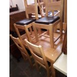 A light oak dining table and six chairs.
