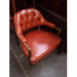A red leather button back captain's style armchair (as found).