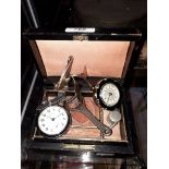 A vintage jewellery box containing pocket watch, desk watch, whistle and bottle opener.