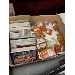 A box of assorted tea and cigarette cards.