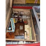 A vintage case containing various collectables including games, ships in bottles, cufflinks, cut