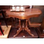 A reproduction inlaid mahogany fold top card table.